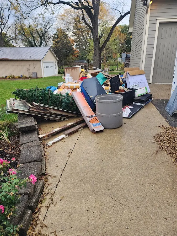 Dumpster being loaded with debris for 12 Yard Dumpster Rental in St. Louis Park
